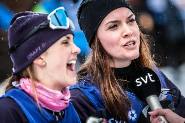 Två kvinnor i västar intervjuas med mikrofon