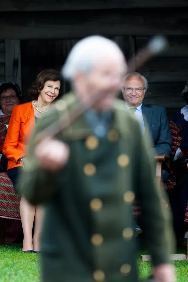 Suddig äldre man i uniform med publik som sitter bakom